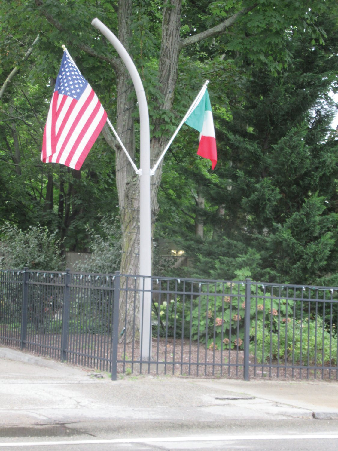 CLASSIC COLORS: Telephone poles located along the southern section of Atwood Avenue are adorned with American and Italian flags that are always flying during the annual Saint Rocco’s Feast and Festival that will return on Thursday, Aug. 12.